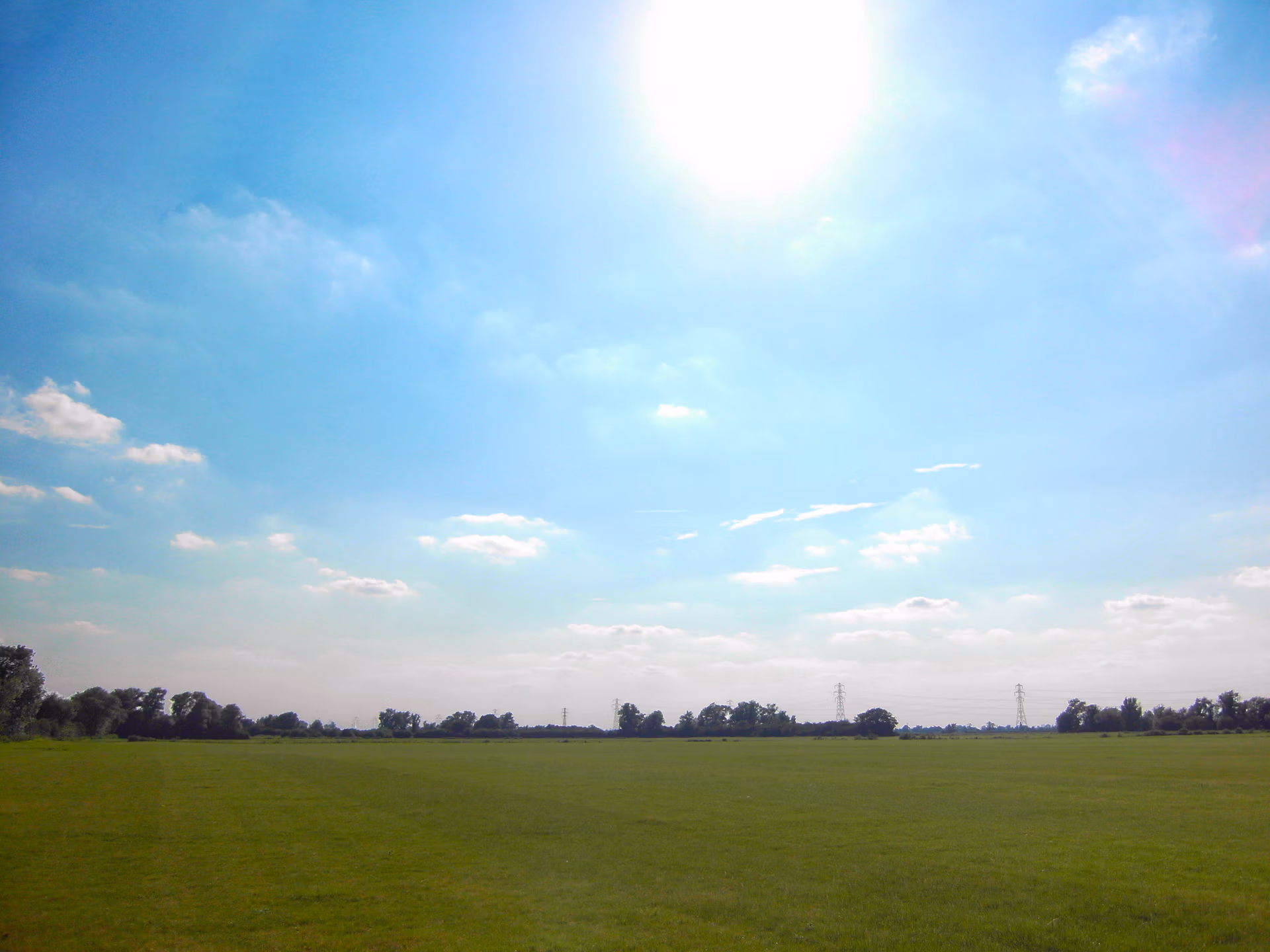 Sunny Fields of LodeStar Festival with perfectly mown grass empty and ready for the festival build. Stages, sound and lighting, toilets, caterers, volunteers and festival crowd soon to arrive from Cambridge and surrounding villages.